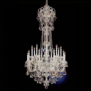 A massive multi-tiered 18-light crystal chandelier hanging in a luxury high-ceiling room with brilliant light refraction.