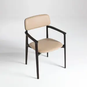 Modern dark ash wood armchair with soft pink upholstered seat and backrest.