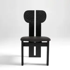 Front view of a black sculptural ash wood dining chair with a split circular backrest design.