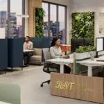 A modern open-plan office featuring customized RST brand furniture, ergonomic workstations, and collaborative pods with professional designers at work.