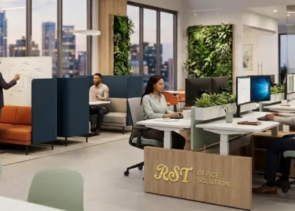 A modern open-plan office featuring customized RST brand furniture, ergonomic workstations, and collaborative pods with professional designers at work.