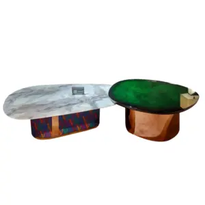 Pair of luxury marble nesting coffee tables in white and emerald green for hotel lobby decor.