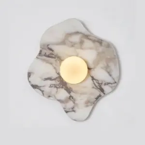 Luxury irregular natural marble wall sconce with frosted glass sphere LED light.