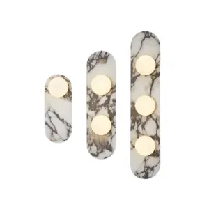 Luxury linear marble wall sconce with three frosted glass globes for upscale hotel bathroom.
