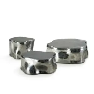 Luxury modern sculptural stainless steel nesting coffee tables in silver with organic pebble shape for hotel lobby.