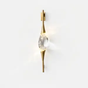 Luxury brass wall sconce with a carved crystal center and integrated LED lighting for hotel decor.