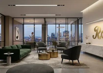 A luxury minimalist office interior featuring integrated smart lighting, green velvet seating, and a large gold RST logo on a white marble feature wall.