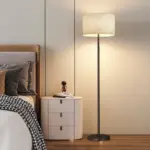 Modern minimalist metal floor lamp with linen fabric shade for luxury hotel decor.