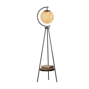 Modern tripod floor lamp with storage shelf and LED globe glass shade for luxury hotel decor.