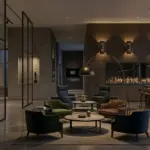 A panoramic view of a luxury commercial bar and lounge interior, featuring a prominent gold script 'RST' logo on a textured stone display wall to the left, mid-ground lounge seating, a well-lit bar counter with stools, and a city skyline through large windows.