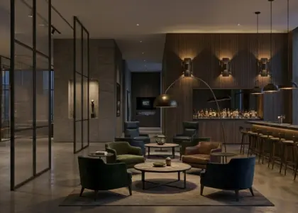 A panoramic view of a luxury commercial bar and lounge interior, featuring a prominent gold script 'RST' logo on a textured stone display wall to the left, mid-ground lounge seating, a well-lit bar counter with stools, and a city skyline through large windows.