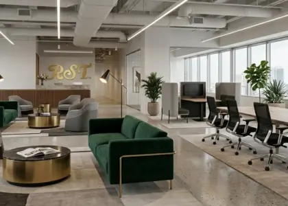 A panoramic view of a modern, open-plan office lounge and co-working area with a city skyline visible through floor-to-ceiling windows.