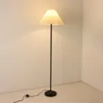 Minimalist 155cm iron floor lamp with white pleated fabric shade, customizable for hotel projects.