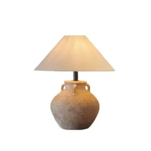 Rustic sand-textured ceramic table lamp with amphora handles and beige conical shade for luxury hotels.