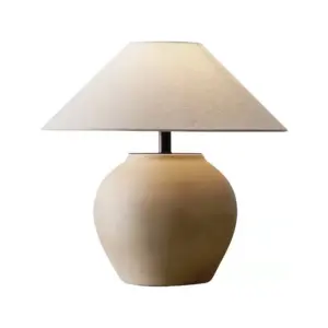 Large minimalist beige matte ceramic table lamp with conical linen shade for luxury hotel lobbies.