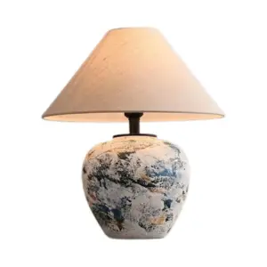 Artistic abstract blue and white ink splatter ceramic table lamp with conical shade for luxury resorts.