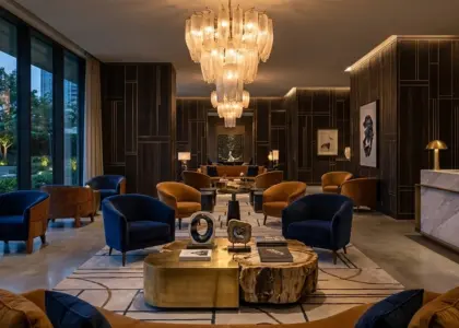 A luxurious panoramic hotel lobby featuring bespoke artisan furniture and gold RST branding, illustrating the future of custom luxury hospitality interior design.