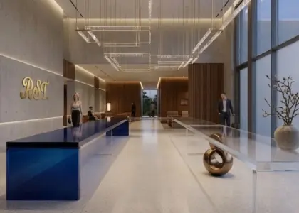 A luxury hotel lobby featuring a long RST Luxury Gradient Acrylic Console Table with a deep blue to clear transition, set against modern wood and concrete architectural elements.