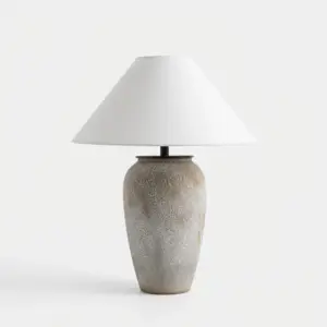 Modern grey textured ceramic table lamp with white conical shade for luxury hotel bedside lighting.