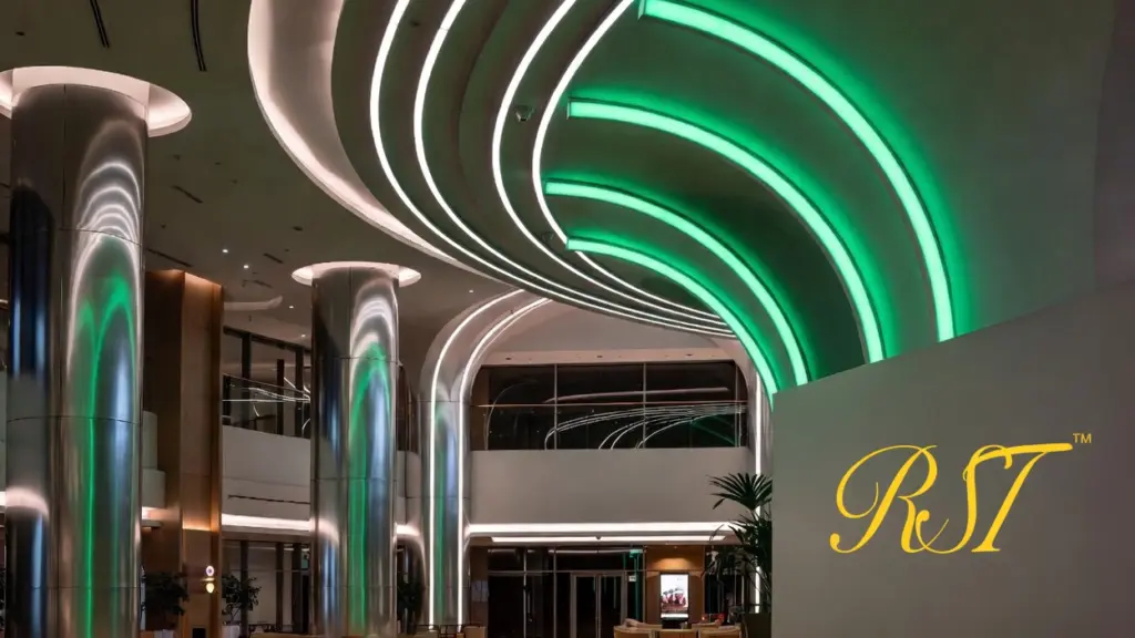 A sustainable modern lighting infographic featuring the RST logo on a green-accented architectural wall, showcasing aluminum recycling symbols, thermal management diagrams for L90/B10 longevity, and smart energy-saving icons for BMS and Zigbee integration.