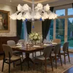 A high-resolution image of a grand crystal chandelier hanging over a dining table with a mix of wood and leather chairs. The table is set for dinner, and a large painting in a gold frame is on the wall.