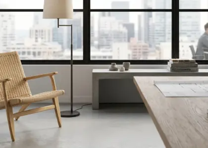 A hand-woven paper cord lounge chair by RST in a modern architectural office overlooking a city skyline, representing high-end contract furniture solutions.