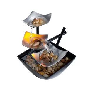 Artisanal Golden Leaf Zen Metal Water Fountain with multi-tiered leaves and river stones in a textured basin.