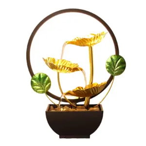 Artisanal Golden Ginkgo Leaf Zen Metal Water Fountain with gold leaves, river stones, and cascading water.