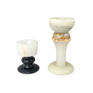 Luxury custom marble candle holder featuring a translucent onyx top and a polished black marble base for hotel decor.