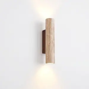 Customizable luxury travertine wall sconce with dual-directional warm LED light and solid wood base.