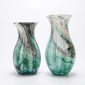 Handcrafted emerald green Liuli glass vase with vibrant organic swirls and a polished finish for hotel decor.