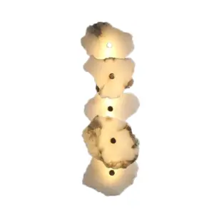 Customizable luxury vertical wall sconce made of natural alabaster stone with warm LED light for hotel lobbies.