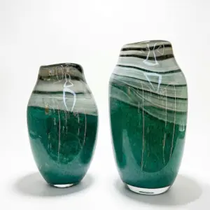 Handcrafted deep sea blue Liuli glass vase with vibrant organic swirls and a polished finish for hotel decor.