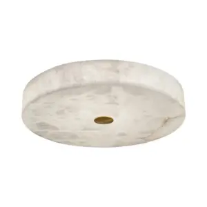 Luxury circular alabaster flush mount ceiling light with central brass accent for high-end hotel decor.