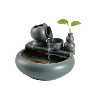 Artisanal Double-Prosperity Zen Ceramic Water Fountain with gourd motif, tiered waterfall, and green plant in a ceramic vase.