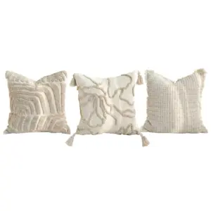 Bespoke White Artisan Throw Pillow collection featuring geometric relief, tufted patterns, and cotton piqué textures with tassels.
