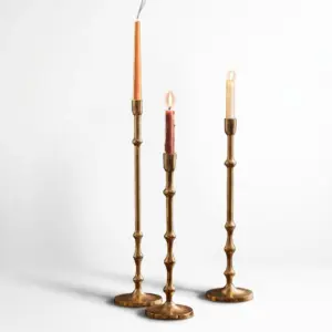 Luxury custom gold aluminum candle holder with a sleek elongated neck for high-end hotel ballroom decoration.