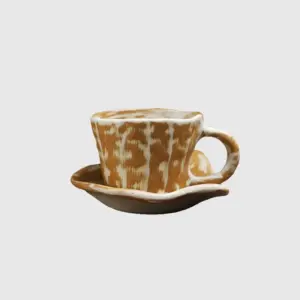 Luxury customizable artisan speckled brown ceramic coffee cup and saucer set with tactile reactive glaze pattern for premium hospitality dinnerware and high-end home decor by RST.
